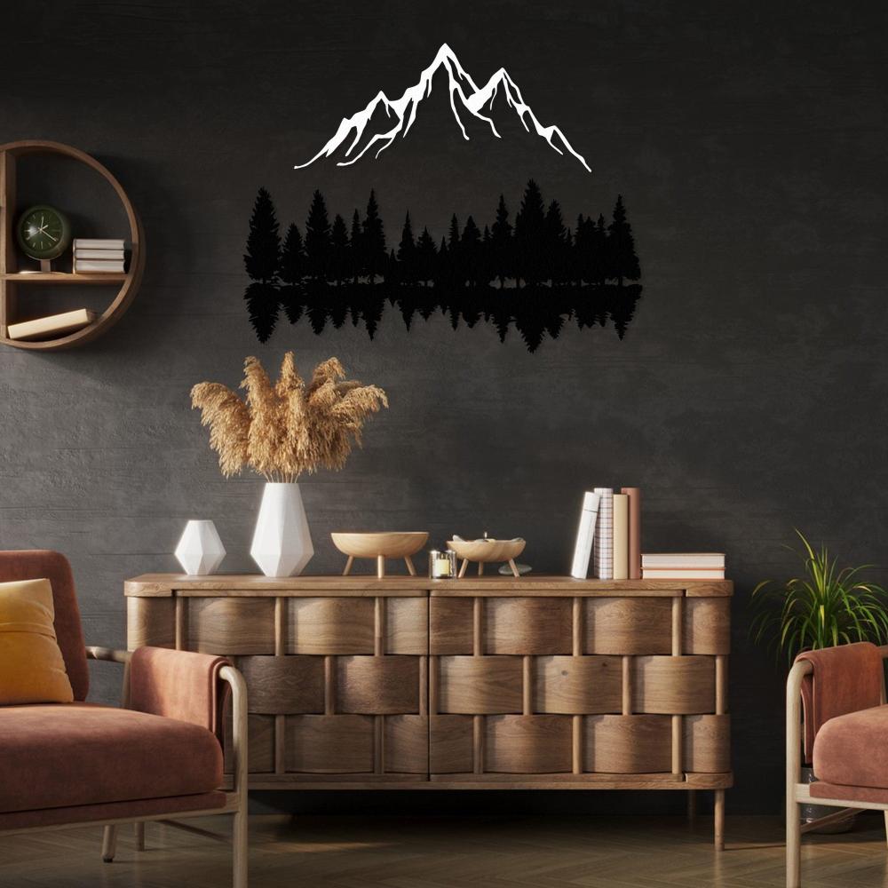 Metal artwork showcasing a reflected forest and mountain scene
