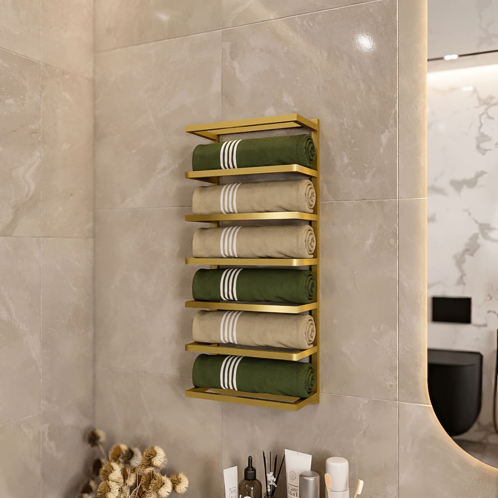 Modern bathroom featuring a gold wall-mounted towel rack that holds neatly rolled green and beige towels. The towel rack is fixed on sleek, light grey tiles, adding a touch of luxury and organization to the bathroom decor.