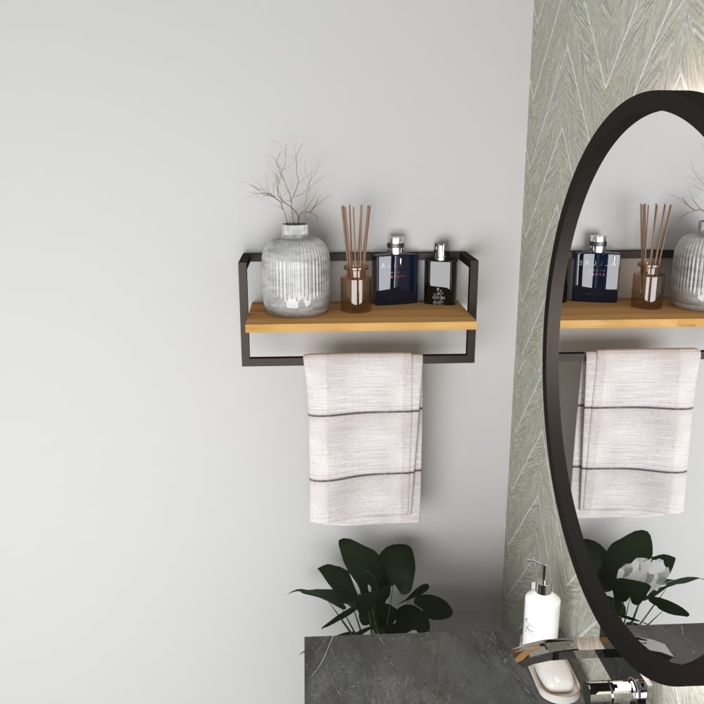 A closeup of a black metal and wood bathroom shelf holding decorative items and a towel hanging below, styled with greenery for a modern aesthetic.