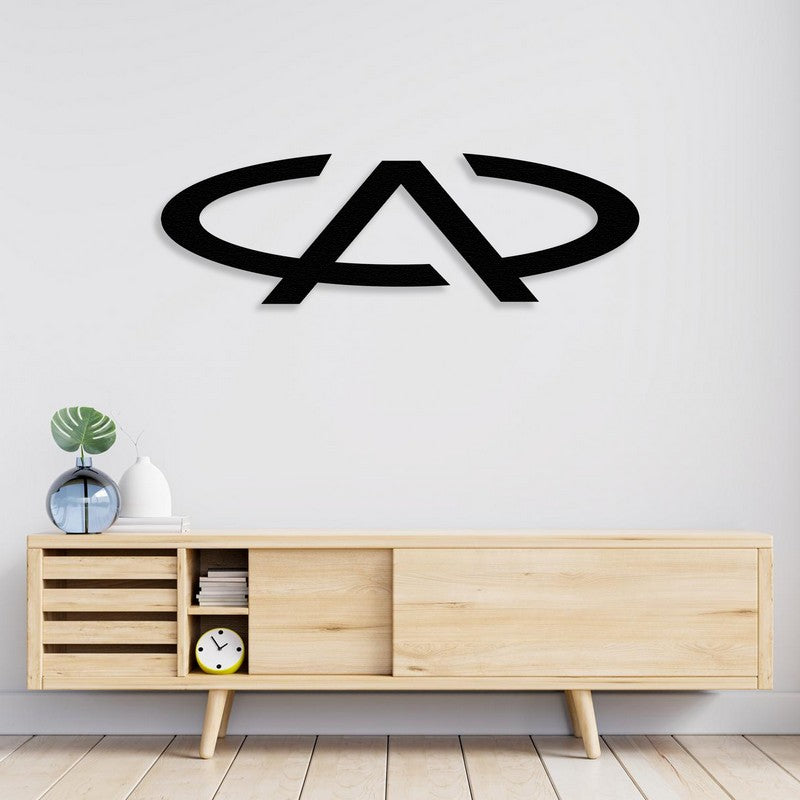 A sleek black Chery Automobile-inspired metal wall art displayed on a white wall above a modern light wood console table, styled with minimalist decor pieces including a clock, books, and a vase.