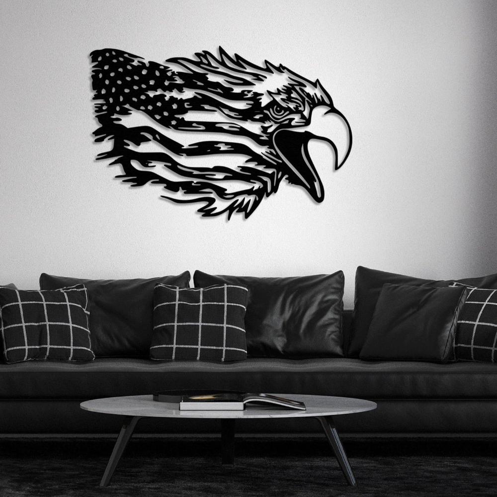 Black eagle metal wall art featuring an American flag design, mounted on a white wall, creating a striking contrast above a modern black sofa adorned with checkered and leather cushions.