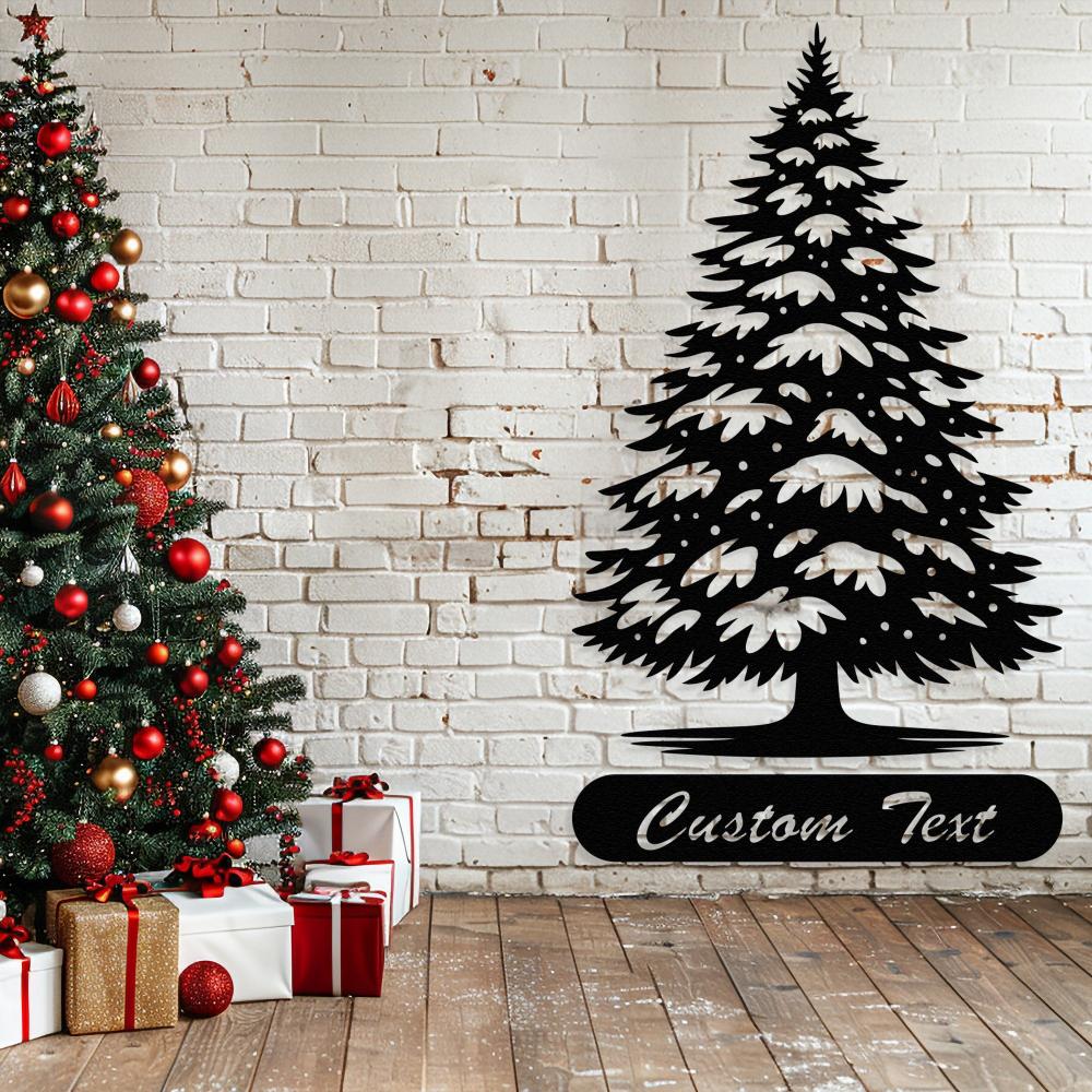 Black metal Christmas tree wall art with customizable text, displayed beside a festive decorated tree and wrapped gifts on a wooden floor with a white brick background.