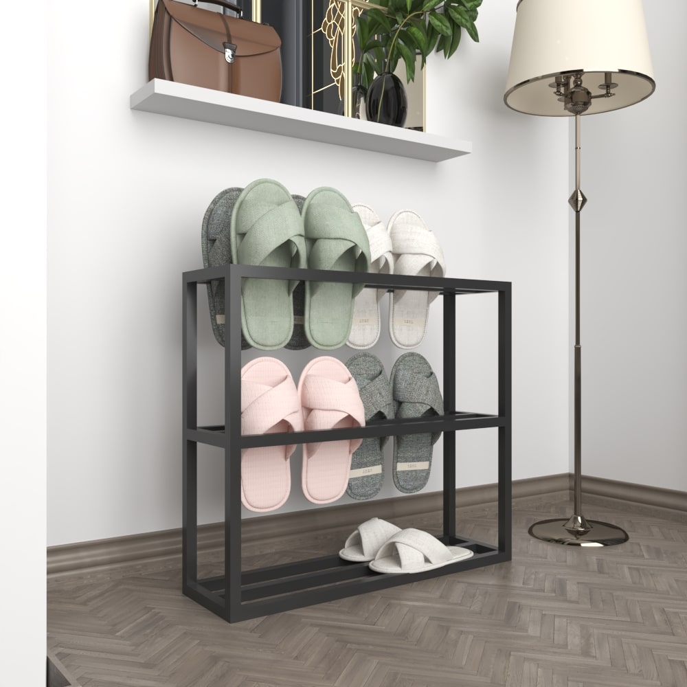  A sleek black metal slipper rack with no slippers, showcased against a plain white background to highlight its clean and structured design