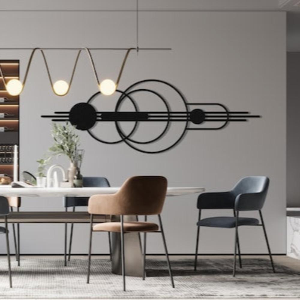 Black mid-century modern wall art with overlapping circles and lines, displayed in a sophisticated dining room with a white table, brown and blue velvet chairs, and a contemporary chandelier.