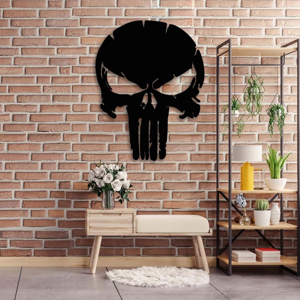 A black Punisher skull metal wall art on a rustic brick wall above a wooden bench, paired with white flowers and a modern shelf with plants and books.