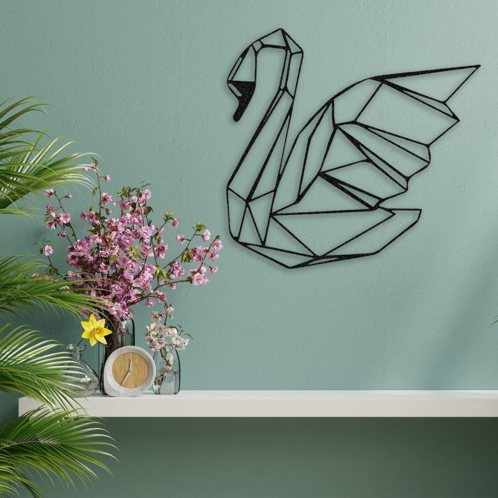 A modern black swan metal wall art on a teal wall, styled with pink flowers and lush green plants.