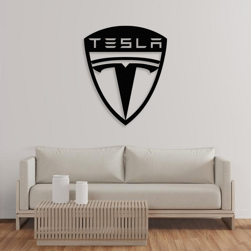 A modern Tesla-inspired black metal wall art design mounted on a plain white wall above a sleek beige sofa with a minimalist wooden coffee table in the foreground.