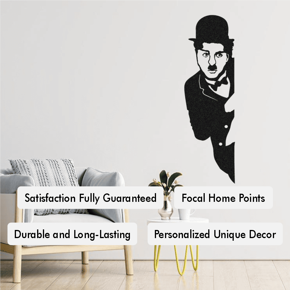 Black Charlie Chaplin metal wall art mounted on a white wall, accompanied by text highlights including "Satisfaction Fully Guaranteed," "Durable and Long-Lasting," "Focal Home Points," and "Personalized Unique Decor." Styled with a modern armchair, a side table with decorative vases, and natural wooden flooring