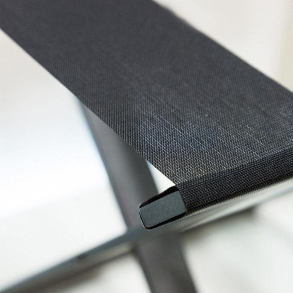 Close-up of the durable black strap on a foldable luggage rack, focusing on texture and quality details.