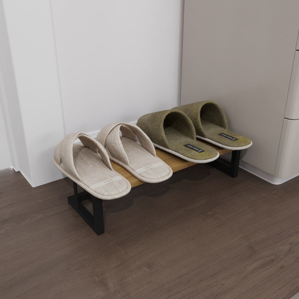 A compact minimalist slipper rack with a wooden platform, holding two pairs of slippers in beige and olive colors, placed against a light wall