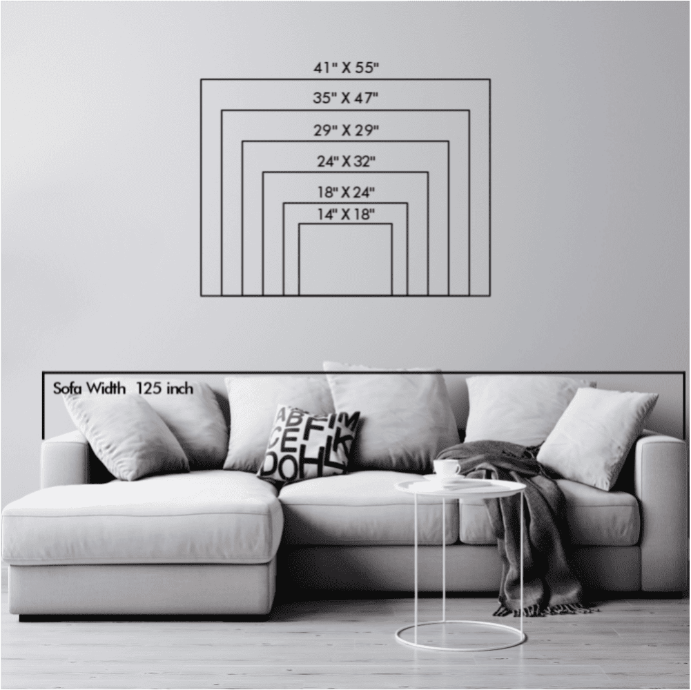 Size chart displaying different dimensions of compass and mountain metal wall art with a sofa width reference for scaling.