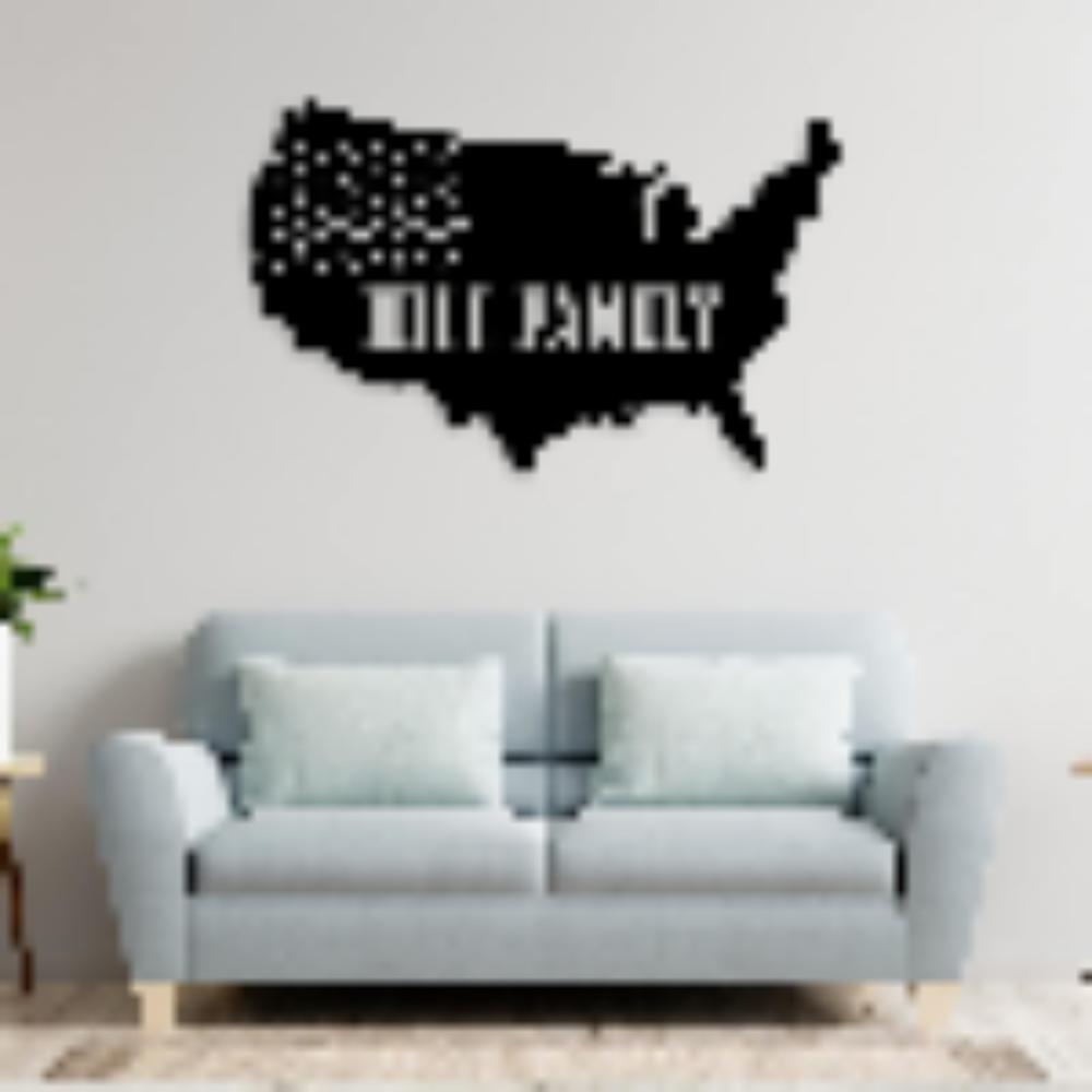 A slightly blurred image of a black metal USA map wall art with the text "Hill Family," mounted above a light blue sofa.