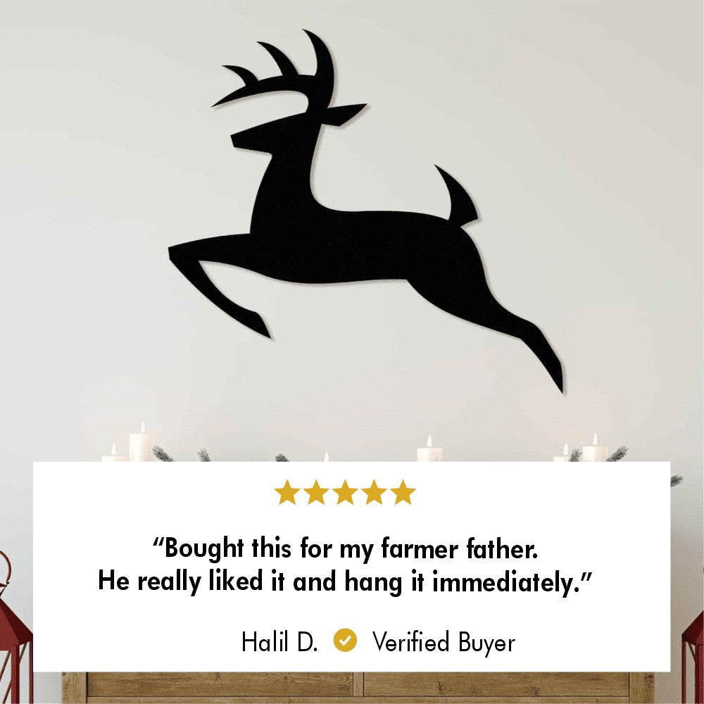 A large metal wall art of a leaping deer, mounted above a cozy fireplace. Below the art is a customer review from Halil D., mentioning how his farmer father loved the gift and hung it up immediately.