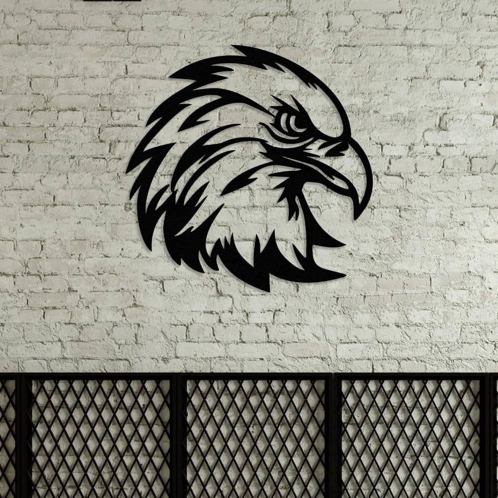 Black eagle head metal wall art against a rustic white brick wall with industrial-style decor elements.