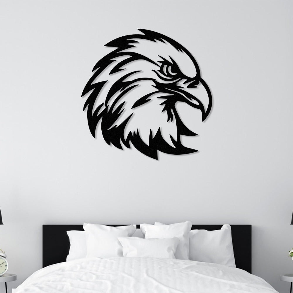 Black eagle head metal wall art mounted above a neatly arranged bed in a minimalist bedroom.