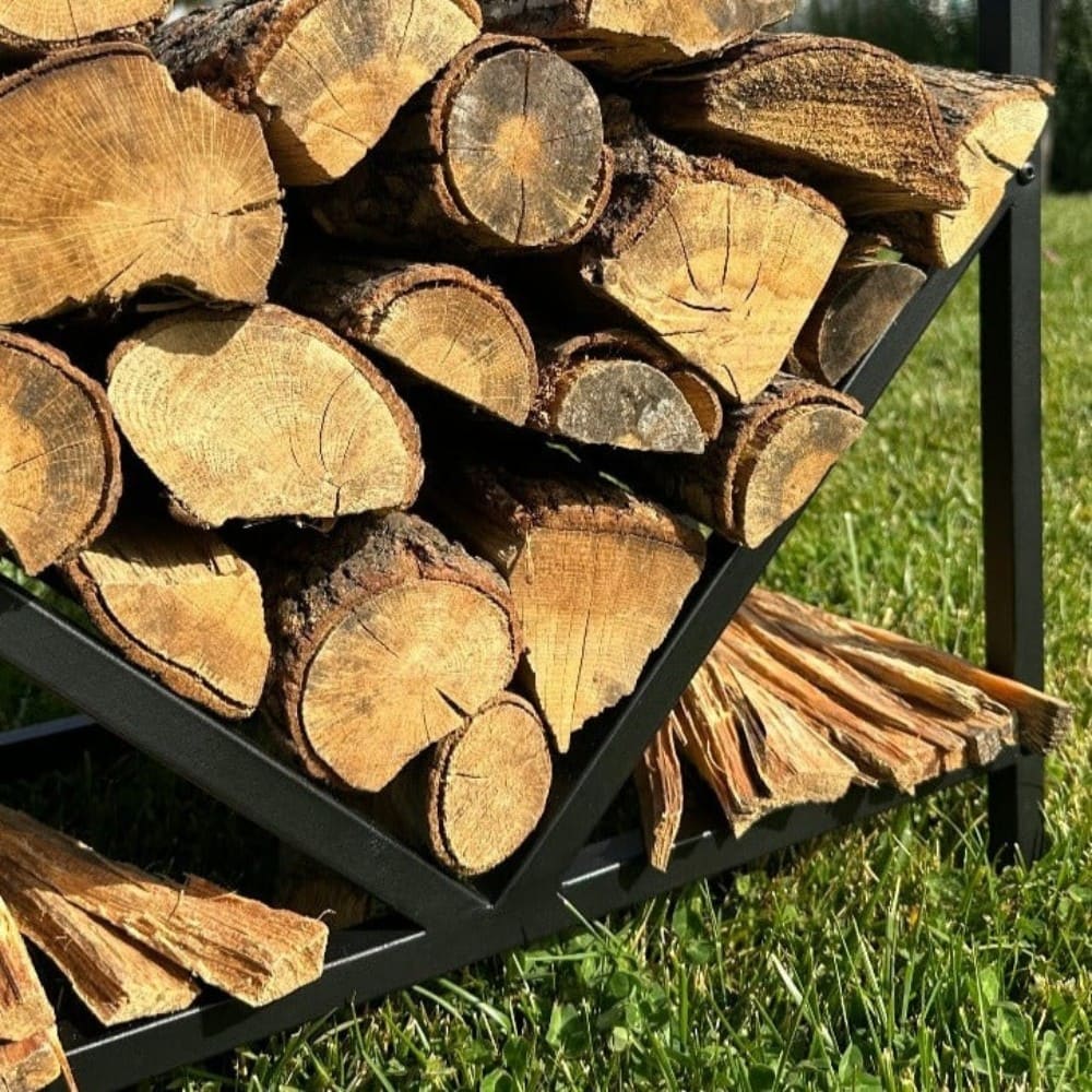 A close-up view of firewood neatly stacked in a black geometric firewood rack, showcasing the rich textures of the wood and metal frame