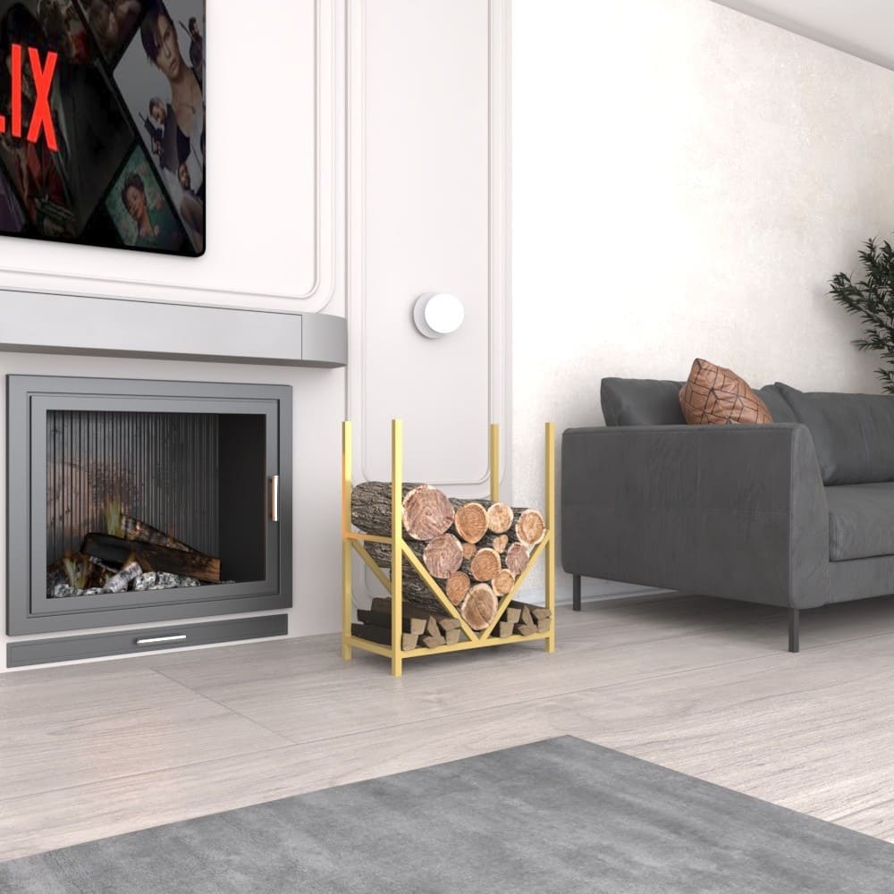 A gold metal firewood rack with a geometric design placed beside a modern fireplace, loaded with neatly stacked firewood, in a cozy living room setting.