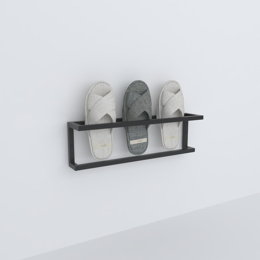 An empty black wall-mounted slipper rack displayed against a white background, showcasing its simple and practical design for home organization.