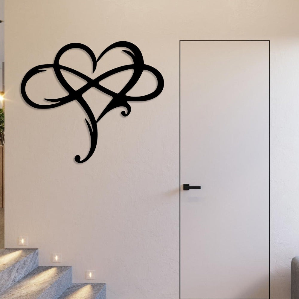 Black metal heart-shaped wall art with intricate loops, mounted on a minimalist white wall near a modern door, alongside a staircase illuminated by recessed step lights.