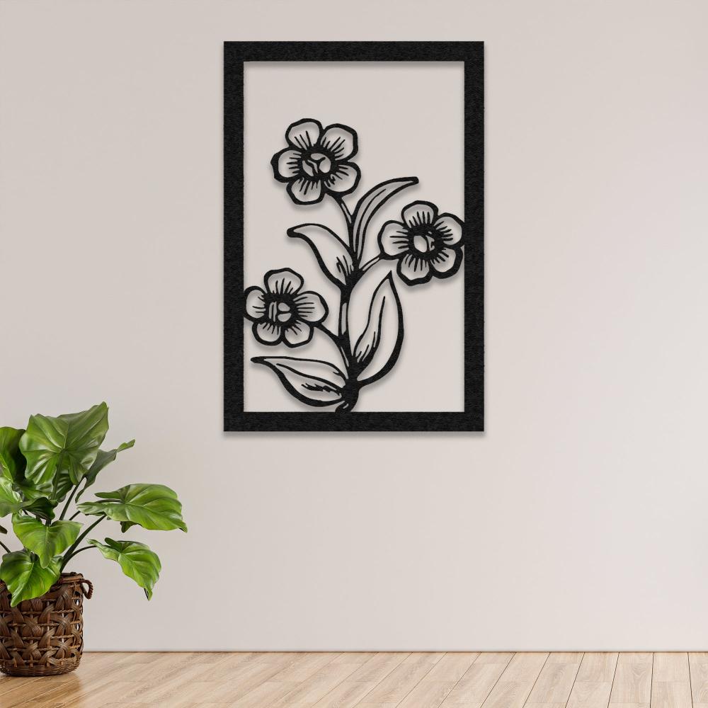 A minimalistic black metal floral wall art featuring three flowers and leaves, mounted on a neutral beige wall next to a woven plant pot.