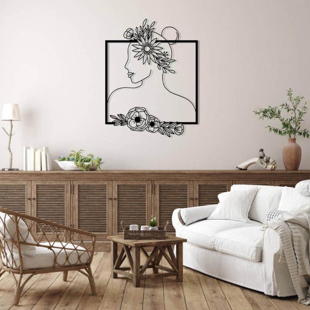 Elegant floral silhouette wall art featuring a woman with a flower crown, displayed above a minimalist bed adorned with earthy-toned bedding and a cotton branch in a vase on a side table.