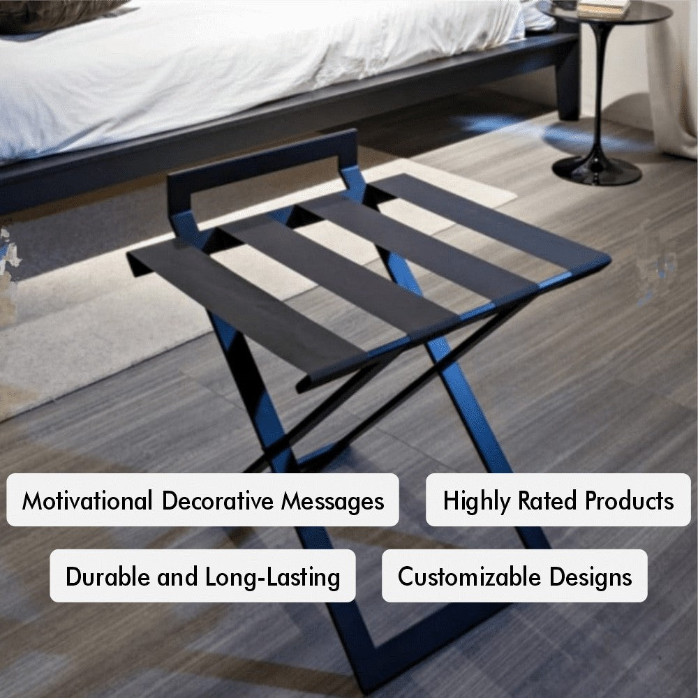 A foldable black luggage rack with leather straps, showcasing motivational decorative messages and customizable design elements, placed near a bed