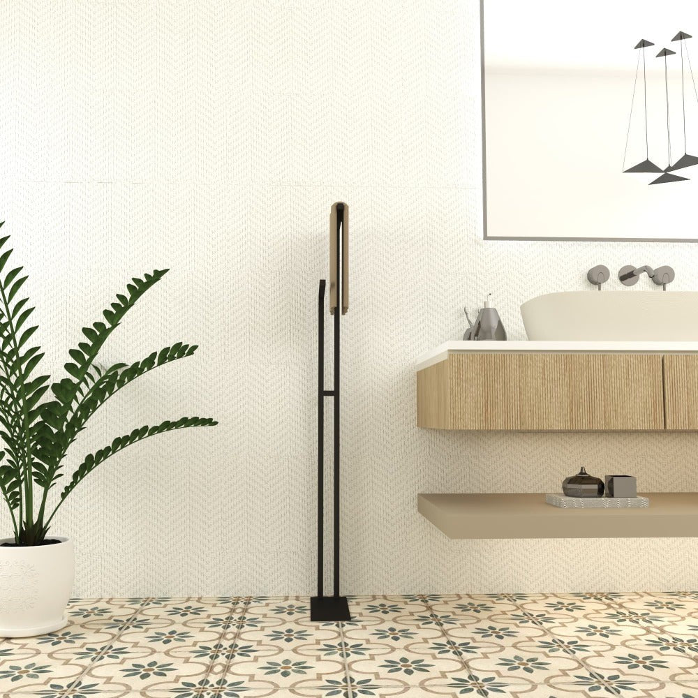 A modern free-standing towel holder in a bathroom setting with beige tiles and a minimalist design, featuring dual bars for towels in white and beige.