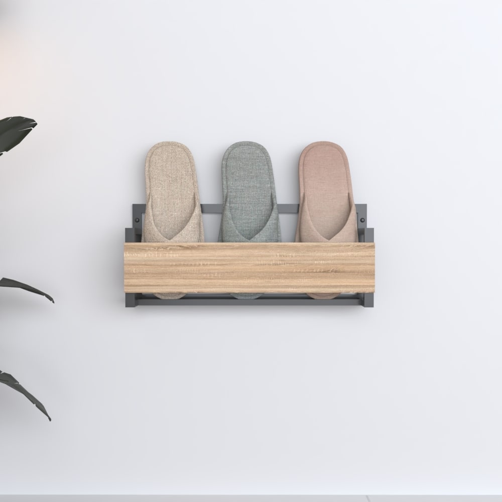 Front view of a wall-mounted slipper rack with a black metal frame and a wooden panel, showcasing three pairs of slippers neatly organized