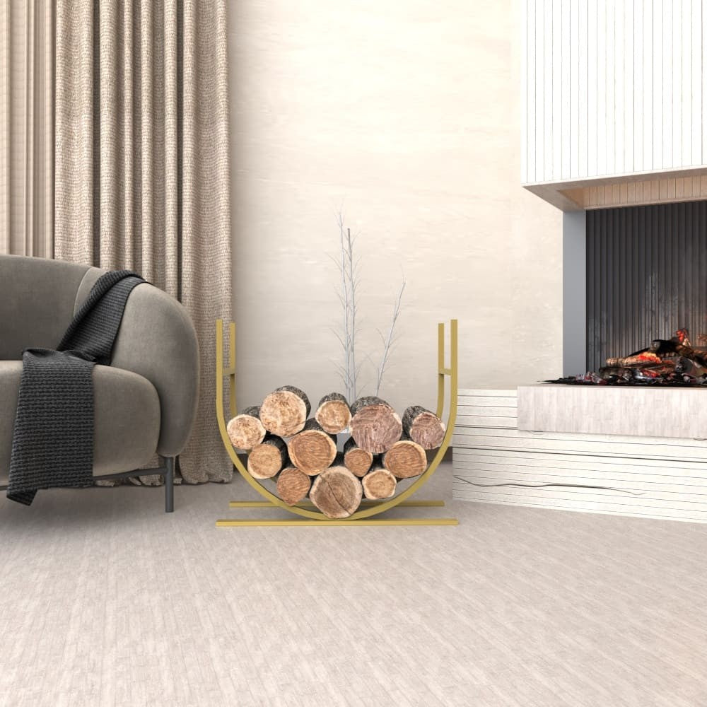 A modern gold oval-shaped metal log holder filled with firewood, positioned in a living room next to a fireplace and a comfortable armchair with curtains in the background