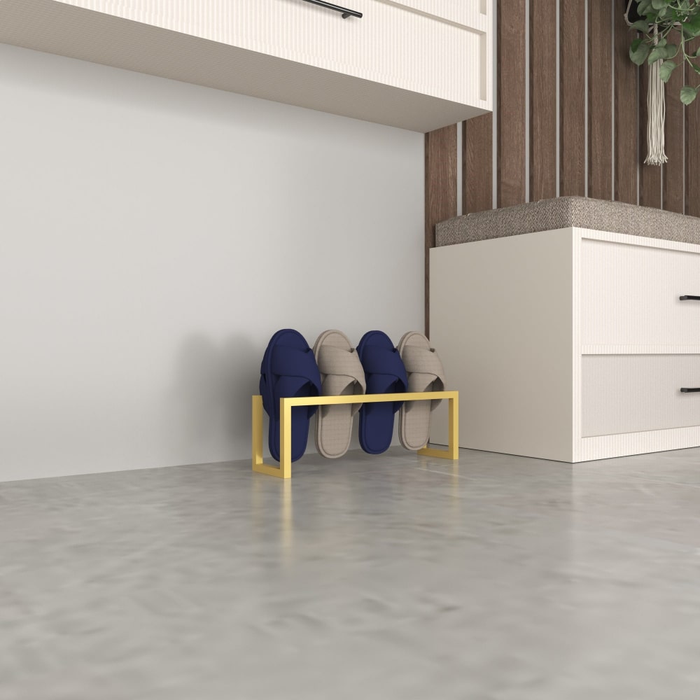 A gold metal slipper shelf holding four slots of slippers, displayed in a modern interior