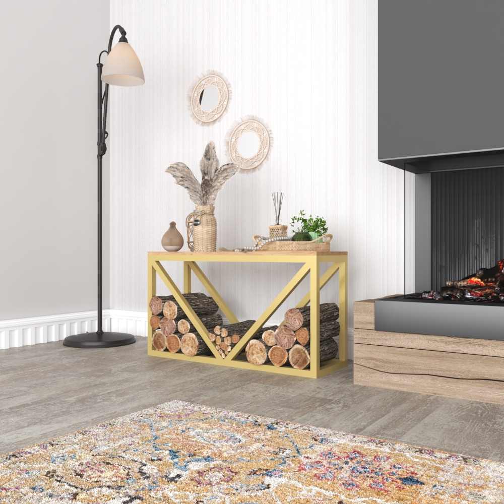 A gold metal wood rack with a wooden top, firewood storage below, and decorative accents on top, placed in a warm indoor setting near a fireplace.