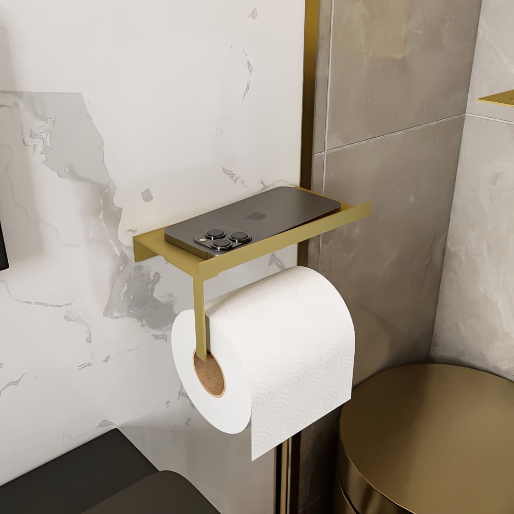 Gold wall-mounted toilet paper holder with a shelf holding a smartphone, set in an elegant modern bathroom with gold accents. 