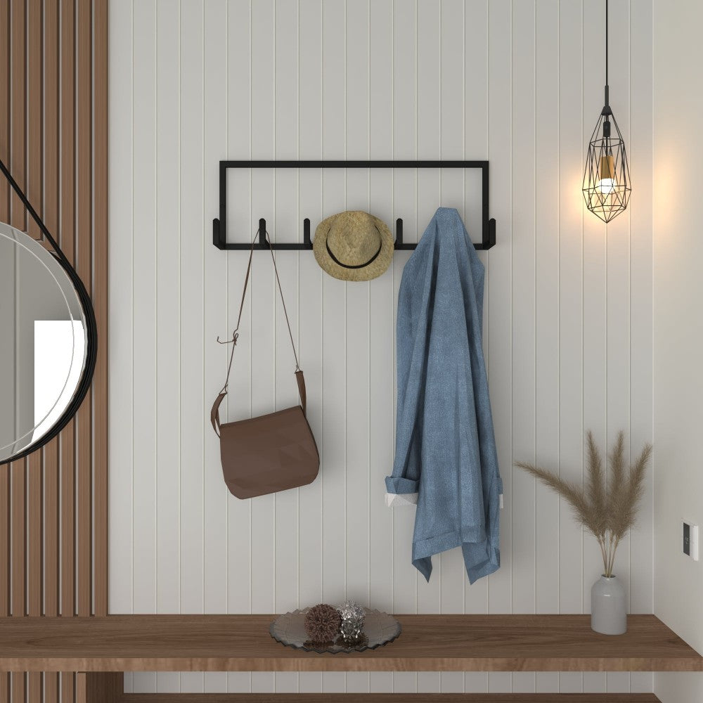 Close-up of a minimalist black coat rack mounted on a white wall, showcasing its simple design for organizing coats and accessories.