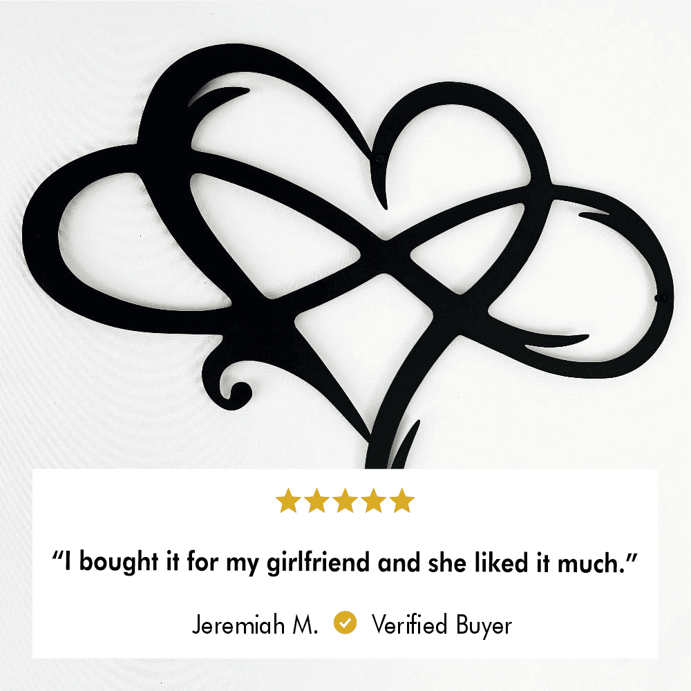 Close-up of black intertwined heart-shaped metal wall art with a 5-star review from Jeremiah M., stating, "I bought it for my girlfriend and she liked it much."