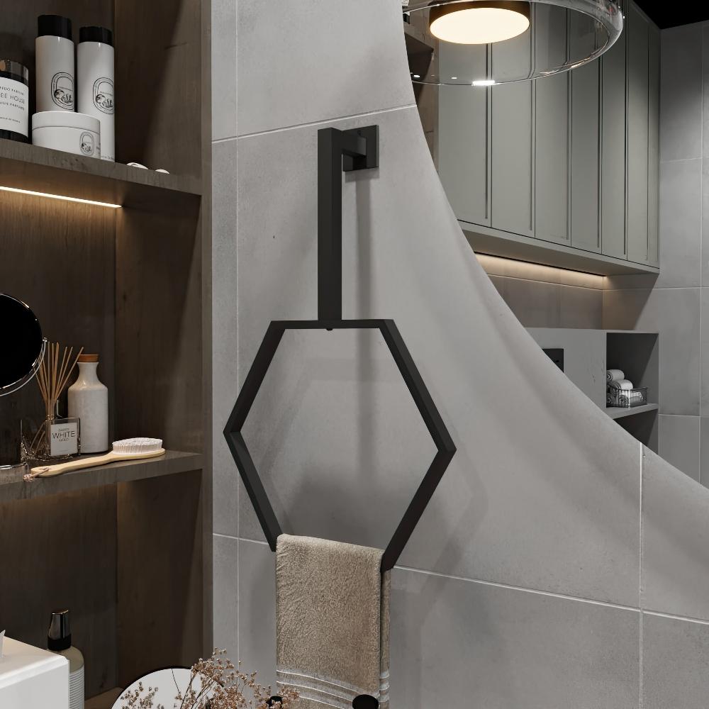 A matte black hexagonal towel ring elegantly mounted in a modern bathroom with neutral tones, featuring a neatly folded beige towel hanging below.