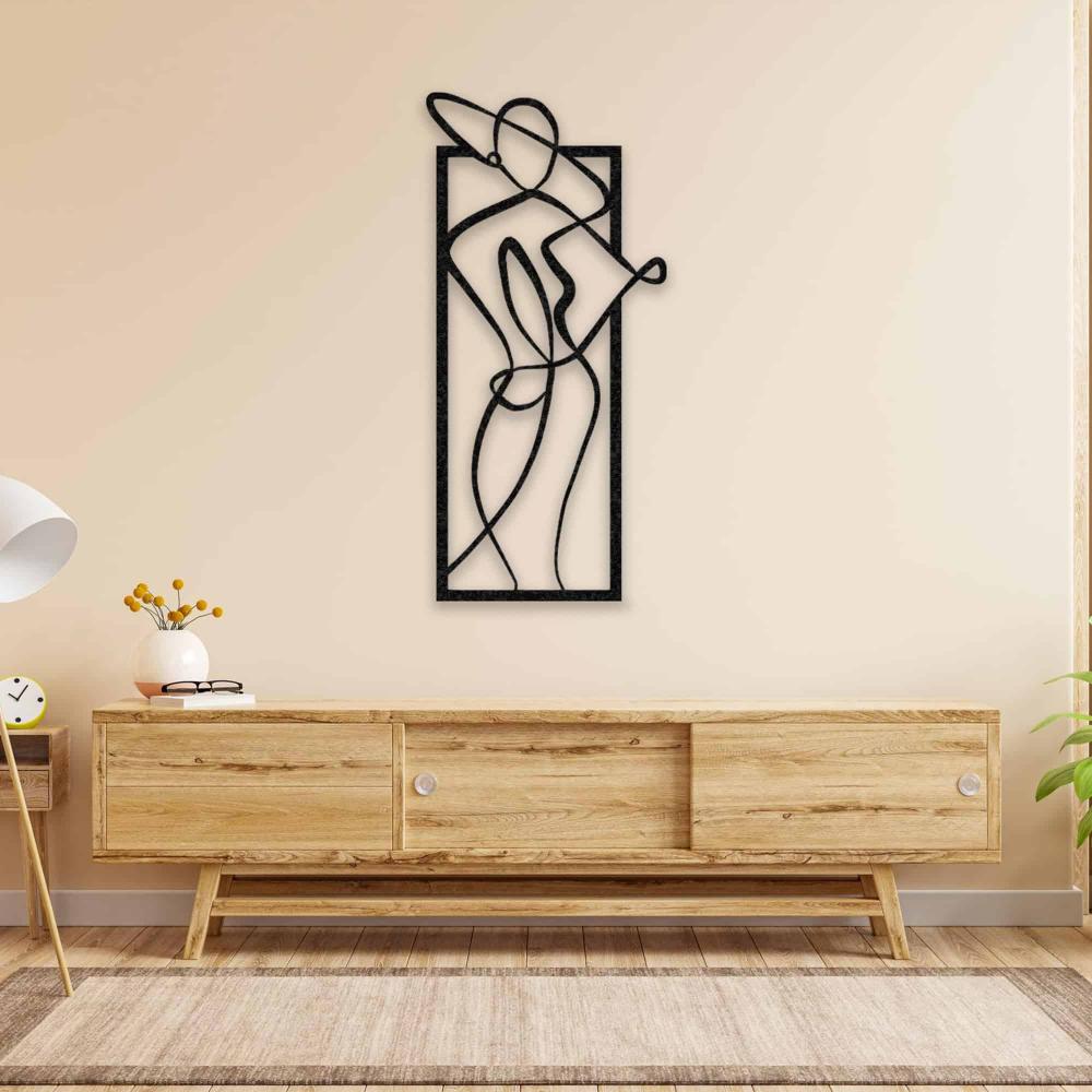 Stylish black metal wall art of a woman in a hat, adorning a beige wall above a Scandinavian-style wooden console.