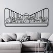 Black metal wall art depicting "The Last Supper" scene, mounted on a light gray wall above a modern gray sofa with white and patterned cushions.