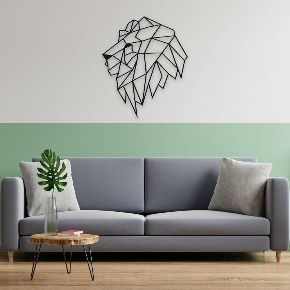 A geometric lion head metal wall art mounted on a green-accented wall above a grey sofa, surrounded by modern minimalist decor.