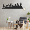 Silhouette metal wall art inspired by a scene from The Lord of the Rings, featuring iconic characters walking in a line. It is displayed in a modern living room with light gray walls, minimalist furniture, and natural accents, including a comfortable chair, side tables, and plants.