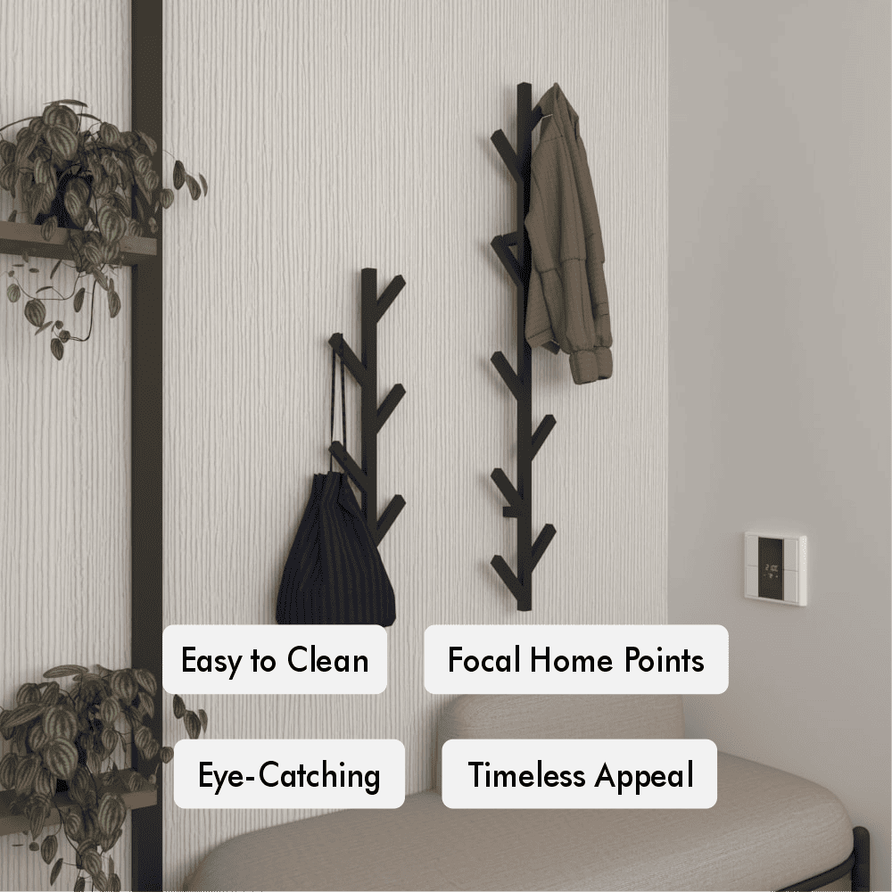 Wall-mounted minimalist coat rack with a tree design, featuring two racks holding a brown coat and a blue bag. The scene includes plants on a shelf, a beige bench, and text labels highlighting features: Easy to Clean, Focal Home Points, Eye-Catching, and Timeless Appeal.