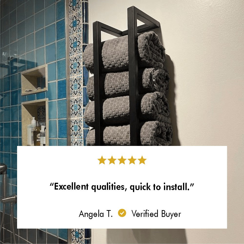 Black wall-mounted towel rack holding grey towels, installed next to a blue-tiled shower with decorative accents, along with a customer review praising its excellent qualities and quick installation.