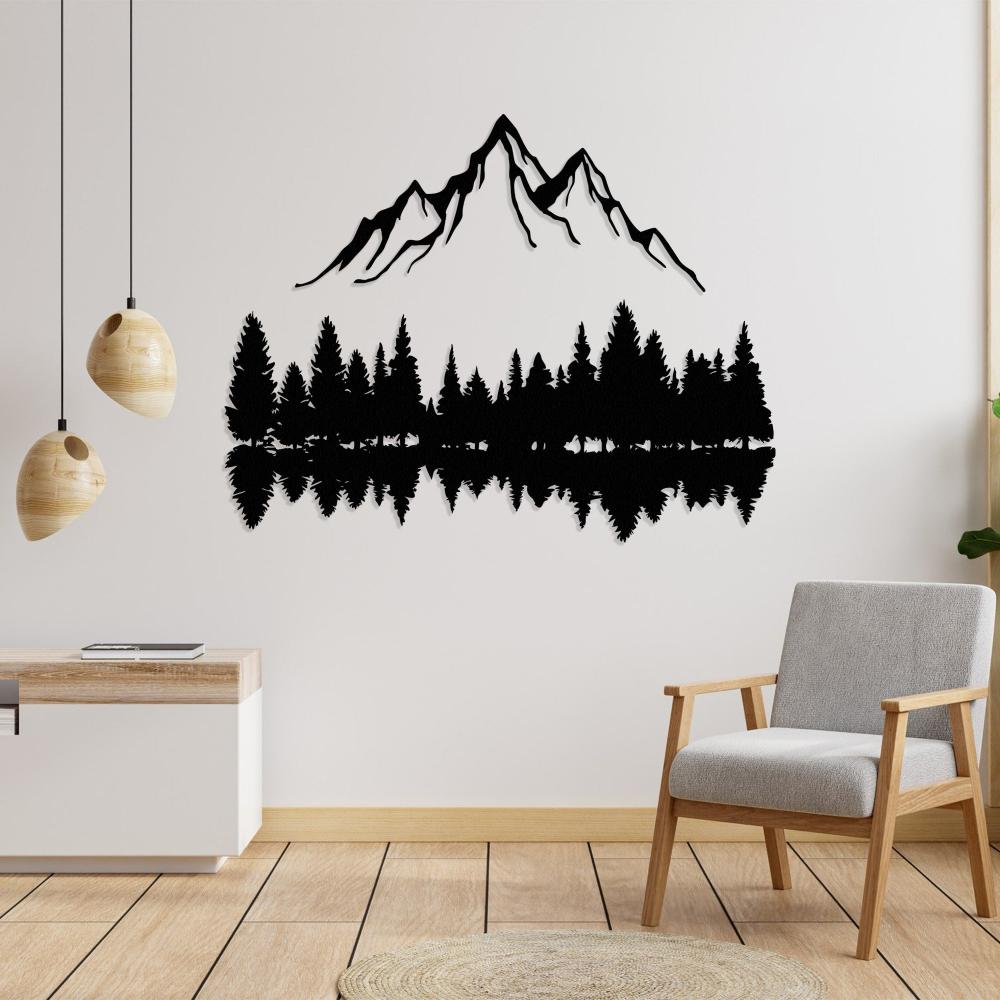 Minimalist landscape wall decor featuring a silhouette of mountains, pine trees, and their reflection. Installed on a white wall with modern pendant lights, a sleek console table, and a cozy gray armchair.