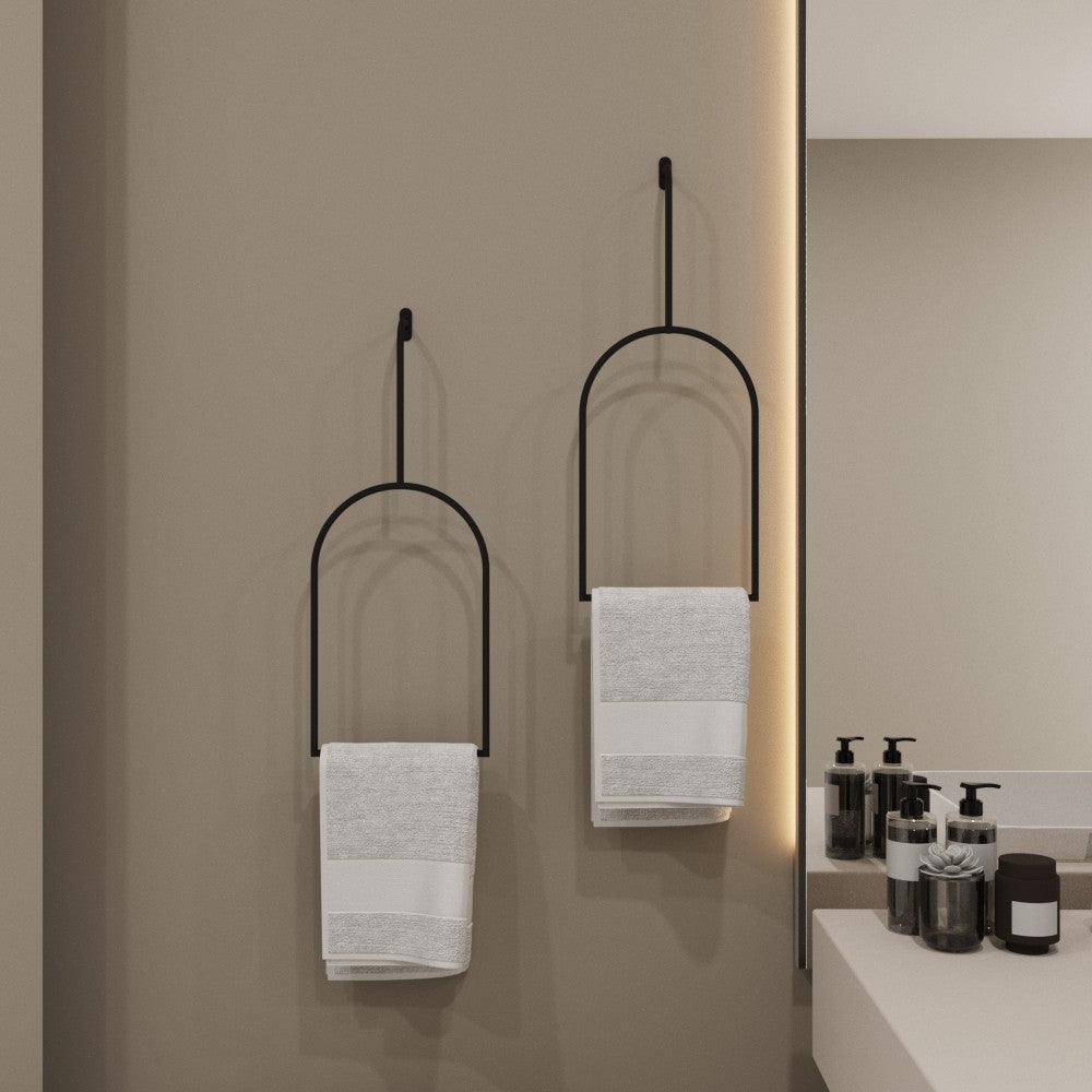 Two minimalist towel rings mounted side by side in a bathroom setting, each holding a white towel, adding a touch of elegance and practicality to the decor.