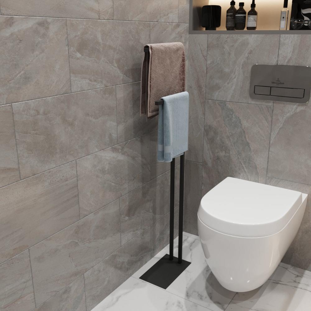 A modern black towel holder with towels placed in a stylish bathroom, highlighting its compact and functional design.