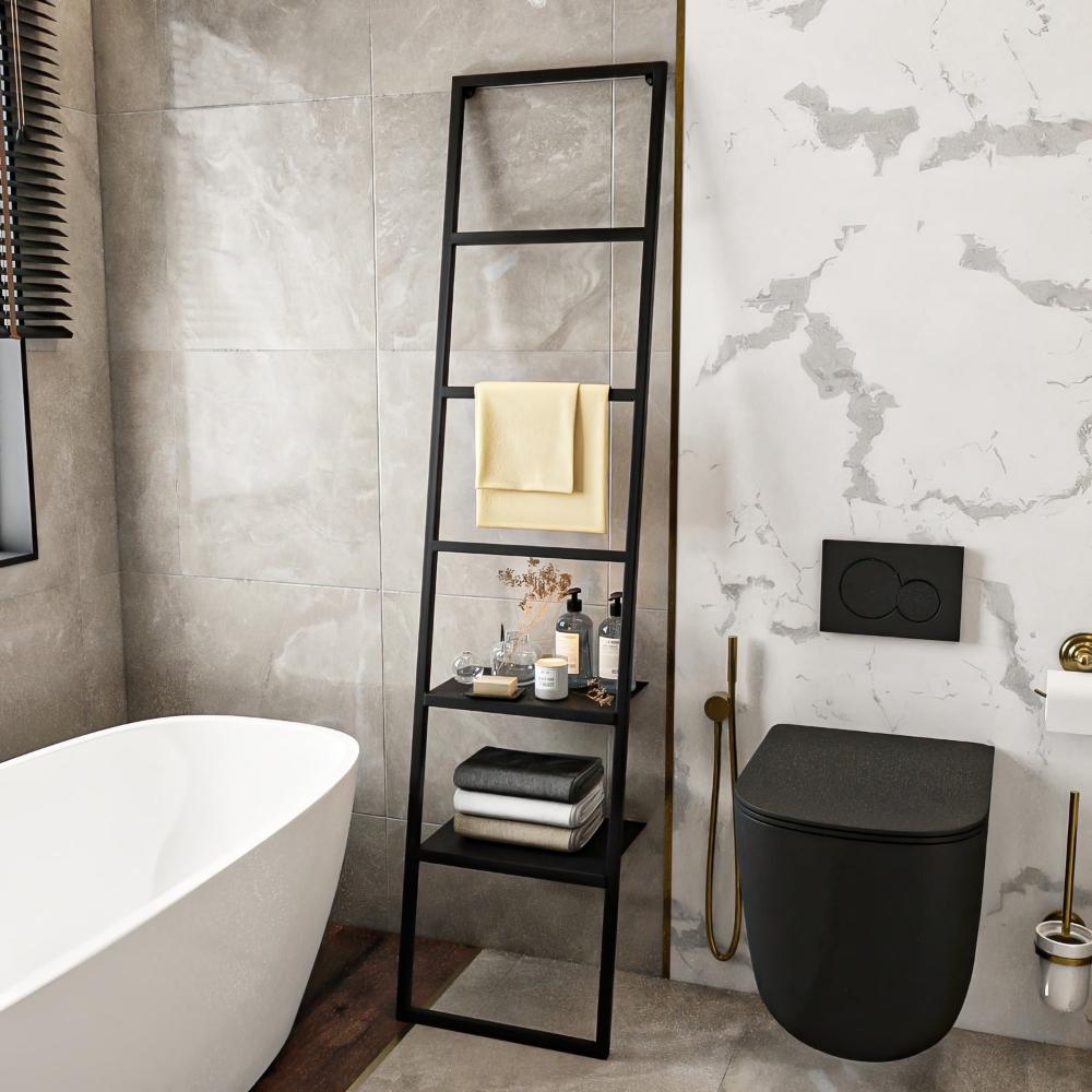 A modern black metal ladder-style towel rack with two shelves in a luxurious bathroom setting, holding towels and decorative items, placed beside a bathtub and a black toilet.