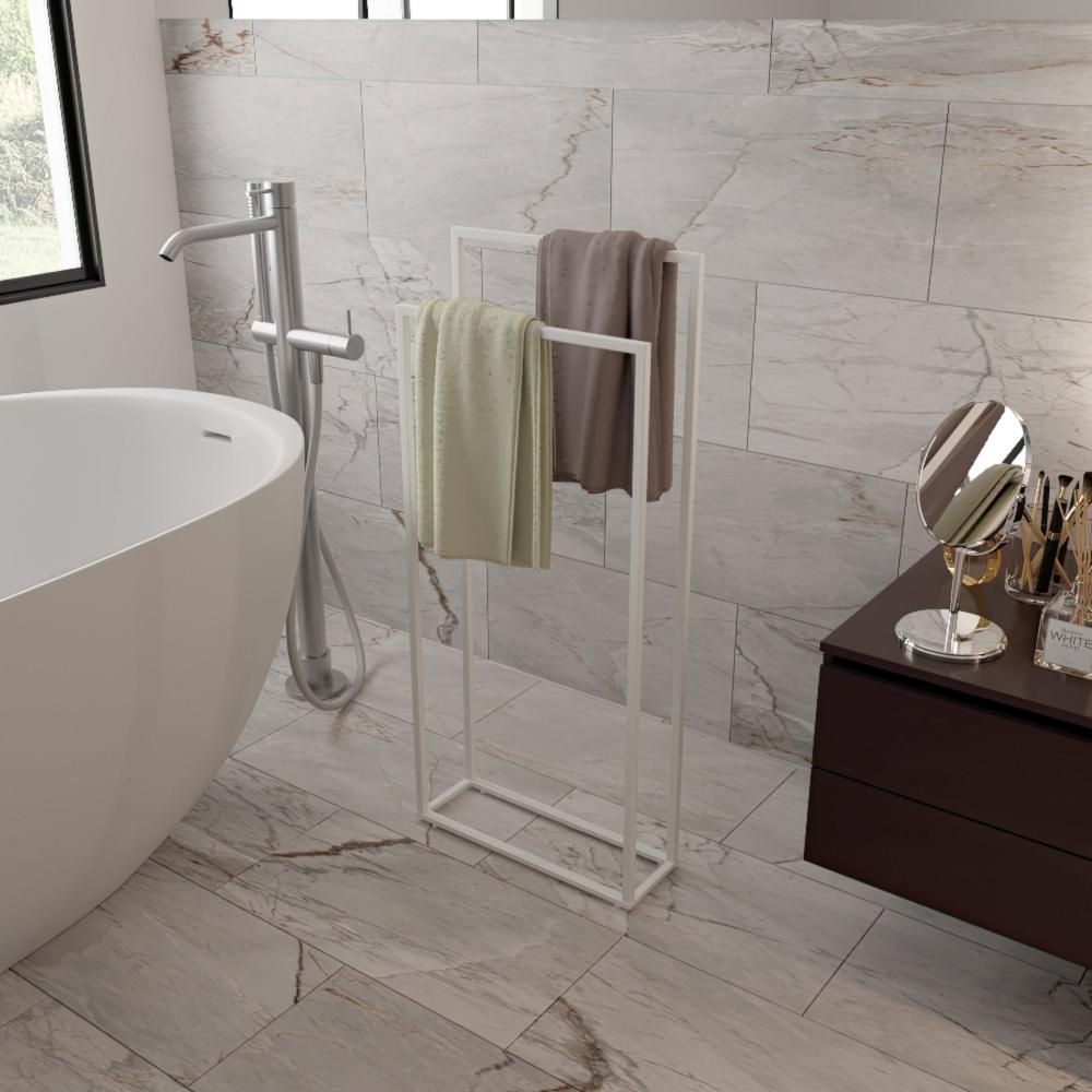 Modern free-standing towel rack in a bathroom setting, featuring a sleek white metal frame and holding two towels against a backdrop of elegant marble tiles.