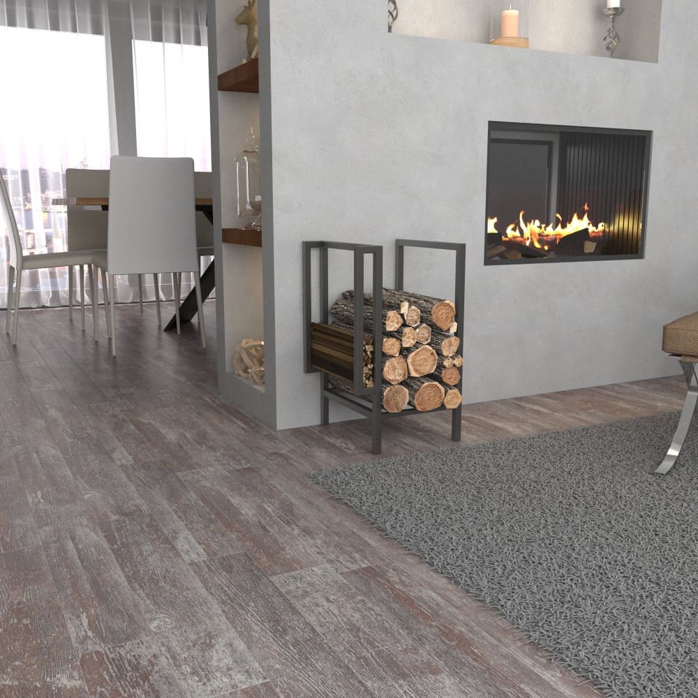 A black metal firewood rack fully loaded with logs, placed beside a fireplace in a bright and modern living room featuring a dining area in the background