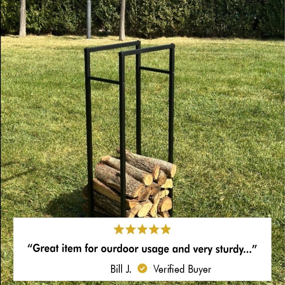 A black metal firewood rack with stacked logs on a grass lawn. A 5-star review below reads: "Great item for outdoor usage and very sturdy..." by Bill J. , a verified buyer."