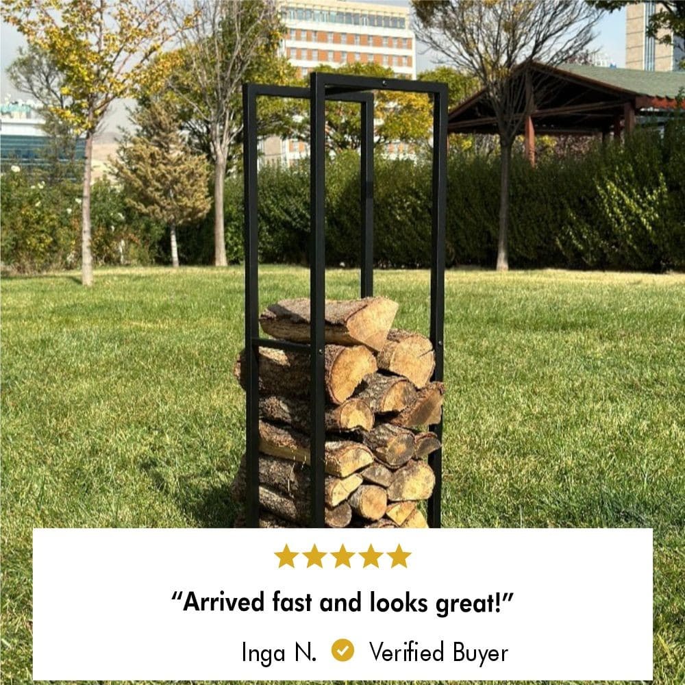 A black metal firewood rack filled with logs on grass, with trees and buildings in the background. A 5-star review below reads: 'Arrived fast and looks great!' by Inga N., a verified buyer.