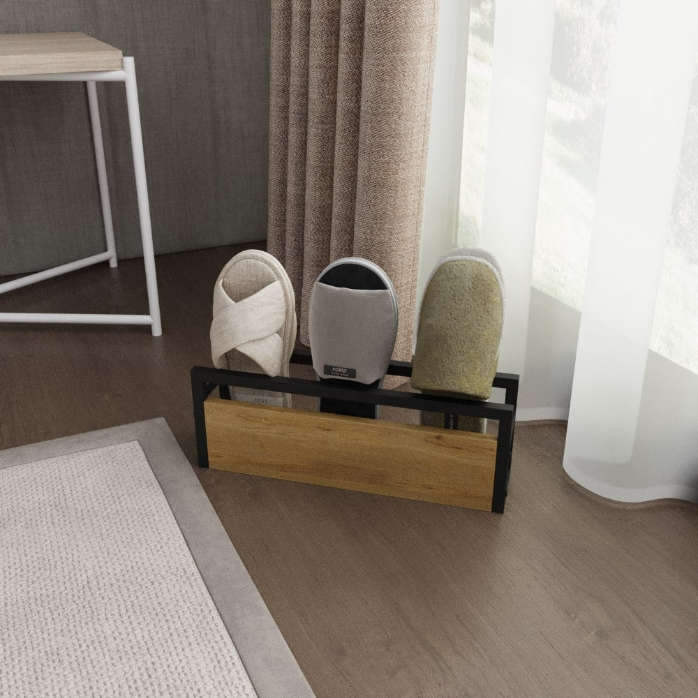 A modern slipper rack with a wooden front panel and black metal frame, featuring three slots holding various colored slippers. It is placed against a window with beige curtains in a cozy room setting